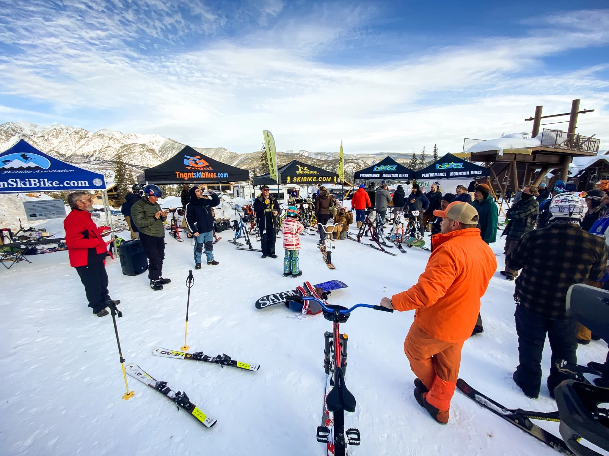 ASA Racing athletes celebrating at the base area with their ski-bikes.