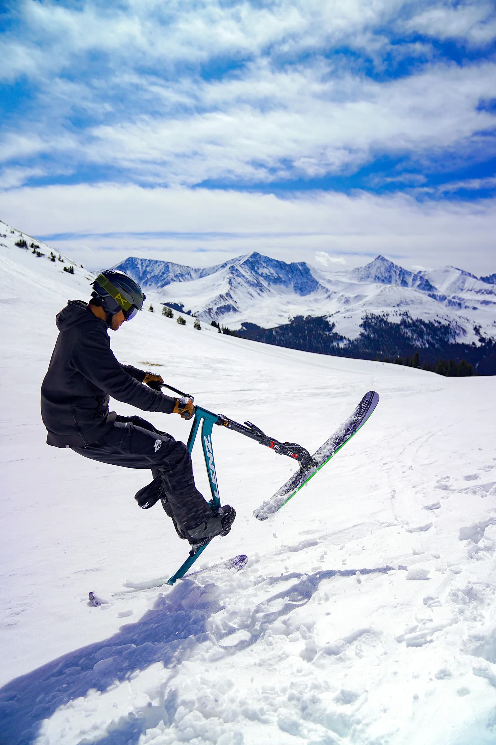 Twilight ski-bike practice session with riders lined up at the start gate.